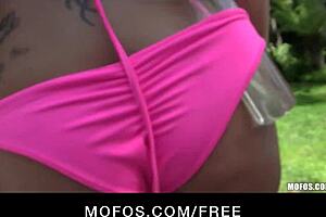 Tattooed blonde in sexy bikini strips and masturbates outdoors