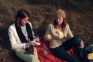 A couple of big-titted brunettes engage in wild lesbian sex with strapon, licking, and face sitting during an outdoor hike