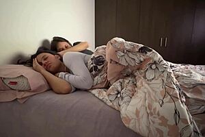 Two girls are having fun in their room, snuggling and playing