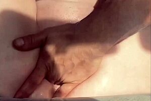 The guy masturbates his cock while watching a pussy squirting video