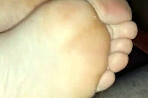 Watch this homemade footjob? Girlfriend's bare toes stroking for huge cumshot!