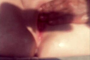 The guy masturbates his cock while watching a pussy squirting video