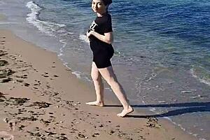 A girl is exposing her pussy on the beach to everyone around