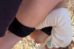 Milf couple caught in forest doggystyle with monster cock and big tits exposed.