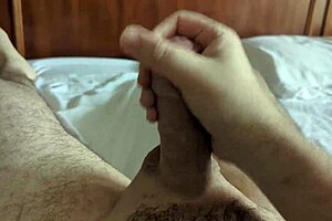 Young amateur jerks off softly on the bed, preparing for a nap in the homemade bedroom.