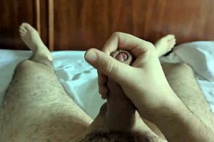 Young amateur jerks off softly on the bed, preparing for a nap in the homemade bedroom.