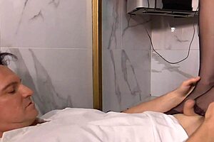 Nylon secretary gives a relaxing footjob in the office