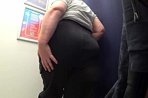 Big-ass curvy milf changes clothes in satin panties, watched by the fitting room camera in this amateur fetish.