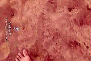 Bare feet exploring sandy shores