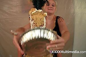 Two blondes get wet and messy and pie each other in the face.