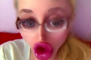 Dollification sissification ramps up with huge pink lips transformation in this bimbo fetish crossdressing session with glasses and lipstick