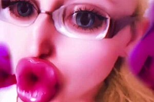 Dollification sissification ramps up with huge pink lips transformation in this bimbo fetish crossdressing session with glasses and lipstick
