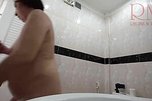 The naked maid cleans the toilet and shower without panties, teasing the boss at work