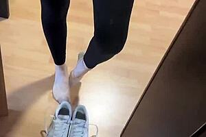 She wakes up early, slipping off her smelly socks to reveal bare feet for fetish fans.