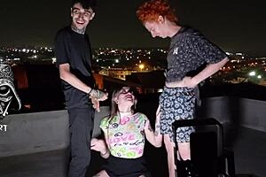 Young Girl Giving To Two Gifted Men On The Roof