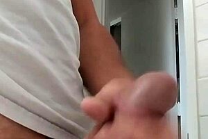 A guy strokes his cock until he cums.