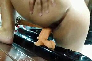 in the motel bathtub, enjoying masturbation with a big toy.