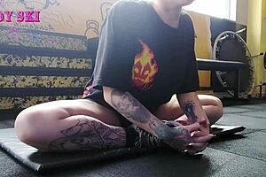 Alternative girl stretching at the gym