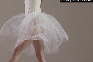 blonde gymnast stretches and performs in the gym