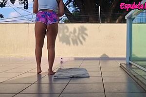 curvy brunette trains outdoors with shorts tucked up her ass