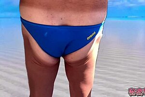 at the beach, she enjoys dicks sticking out of swimsuits during secret masturbation and handjob fun