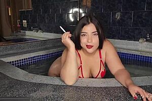 Smoking in the jacuzzi while you worship my tits and ass
