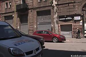 blonde in bondage in latex, bound and flashing outdoors