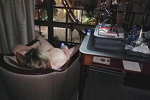 naked and masturbating in front of the city at night