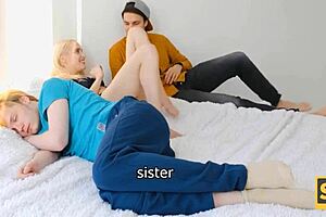 Blond girl enjoys satisfaction behind resting boyfriend on bed