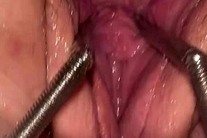 Fist Queen Endures Intense Pussy Stretching with Metal Ring in Extreme Session