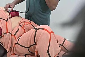 Indian Doctor Thoroughly Checking Lady Patient In Clinic