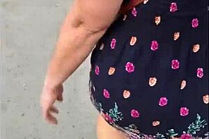 Following mature woman in skirt and thong on street