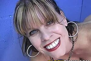 Busty cougar Anjelica sucks big black cock at public gloryhole