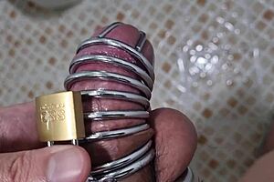 Korslaveman pees while wearing chastity belt