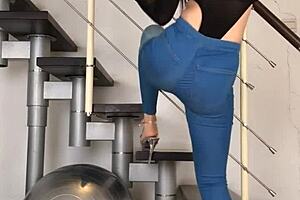 Chinese woman dancing in tight jeans, her tight clothing hugging her body to the music.