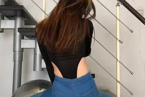 Chinese woman dancing in tight jeans, her tight clothing hugging her body to the music.