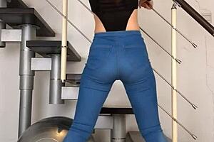 Chinese woman dancing in tight jeans, her tight clothing hugging her body to the music.