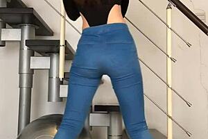 Chinese woman dancing in tight jeans, her tight clothing hugging her body to the music.