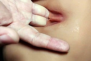 Picking at her pussy while practicing with fuck doll in double penetration.