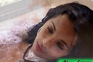 naughty brunette flaunts her stuff at the bar then strips bare in the tub!