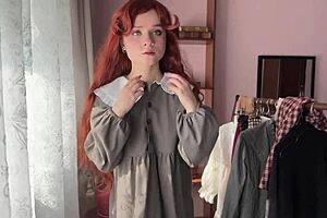 Skinny redhead nerd in stockings poses solo library style