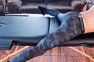 bodybuilder stretches leggings on massage table in hd fetish workout