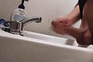 skinny solo dude rests balls on sink for monster cumshot