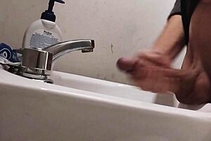 skinny solo dude rests balls on sink for monster cumshot