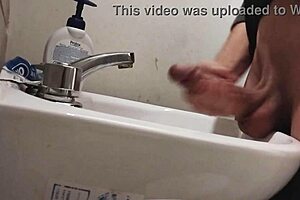 skinny solo dude rests balls on sink for monster cumshot