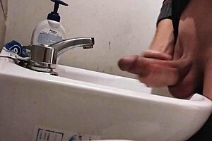 skinny solo dude rests balls on sink for monster cumshot