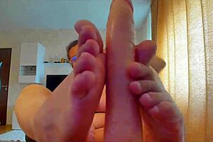 Big titted babe sucks massive dildo then gives intense footjob tease