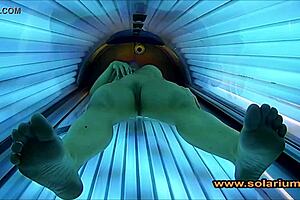 Hidden cam catches cute woman touching herself in solarium glow
