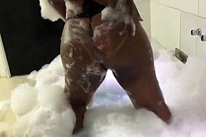 Curvy Brunette Sensually Bubbles in Foamy Bathtub Tease