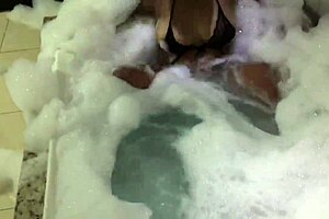 Curvy Brunette Sensually Bubbles in Foamy Bathtub Tease